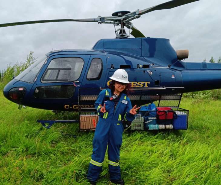 Aliyah standing in front of a helicopter